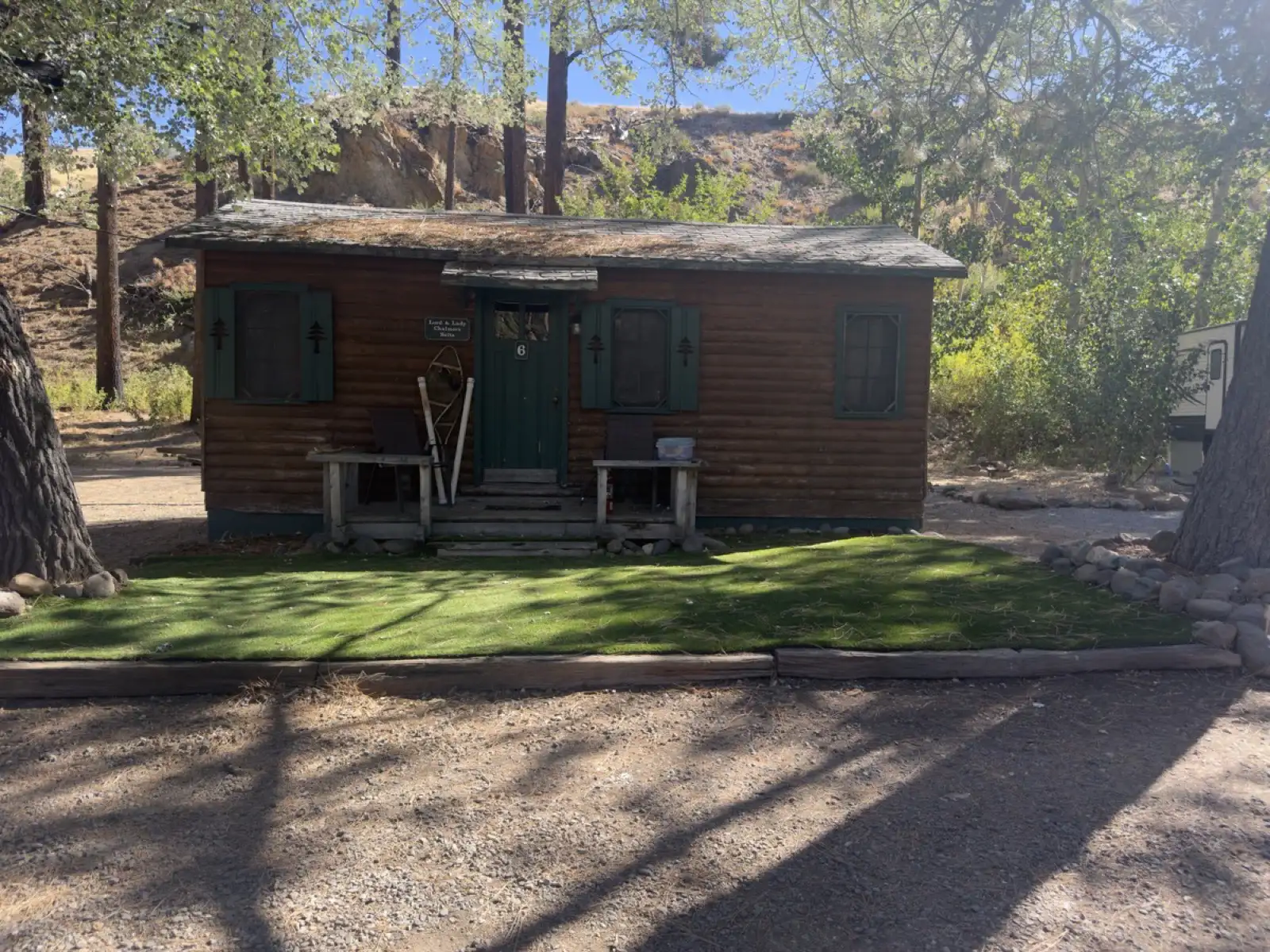 Outside — Cabin №6 from the drive, morning shade.