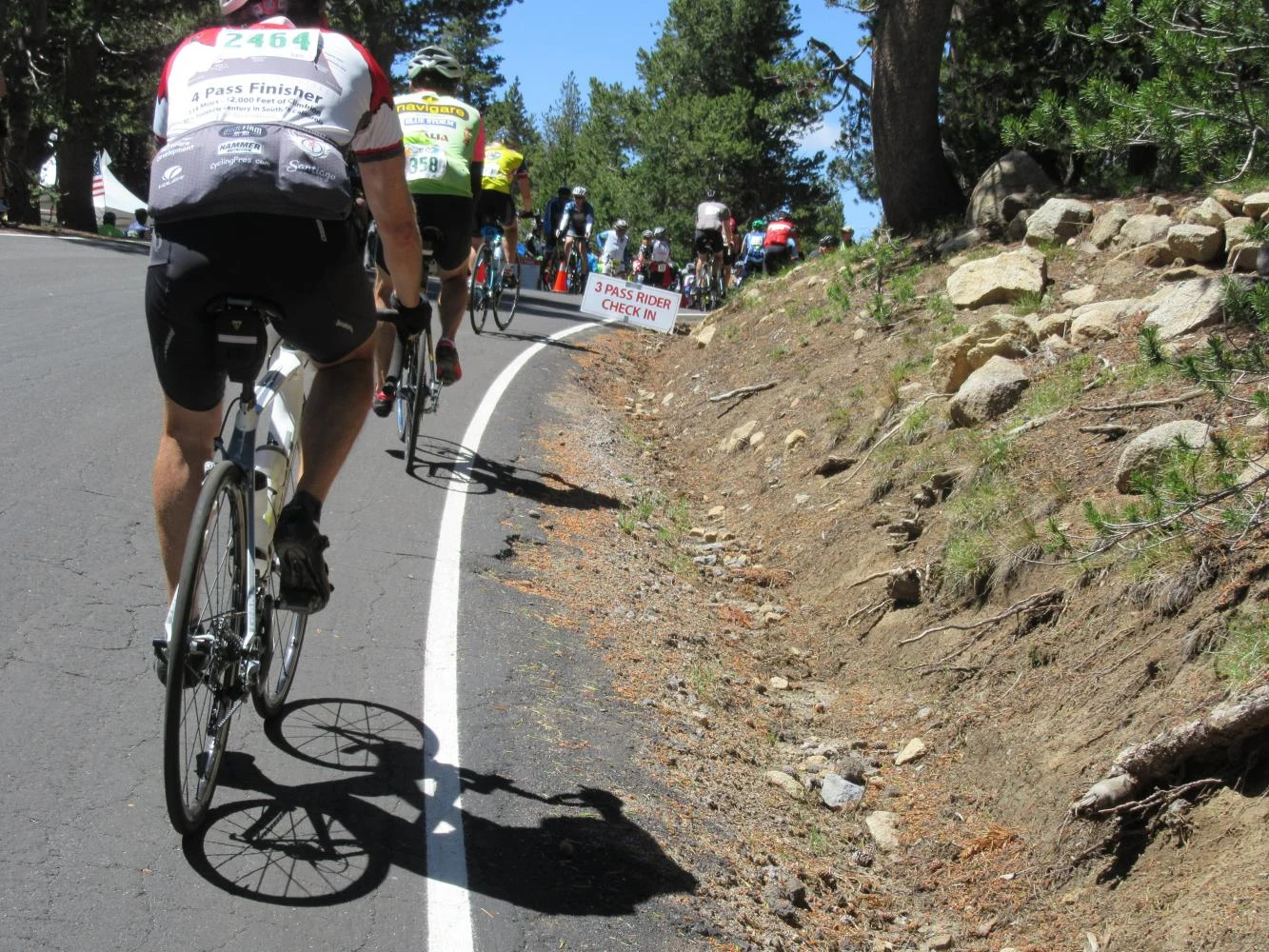 Riders on the Ebbetts Pass climb on Death Ride Saturday, passing the three-pass rider check-in.