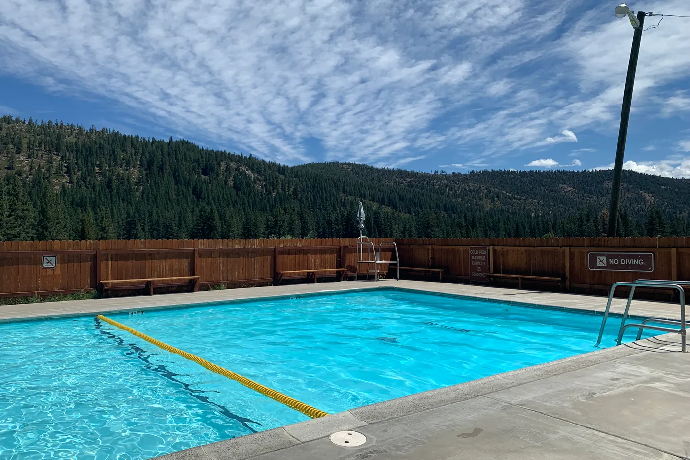 The cold pool at Grover Hot Springs State Park, the ridge behind it — the owner's photograph, July 2021.