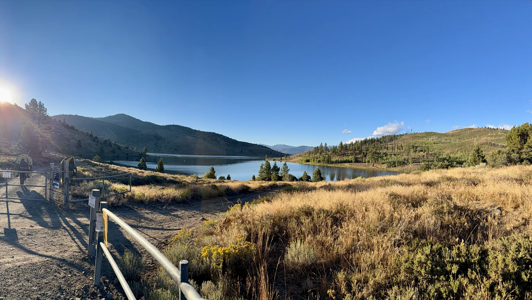 Heenan Lake from the gate at golden hour — 130 acres of it, seven thousand feet up, holding the state's whole Lahontan cutthroat broodstock.