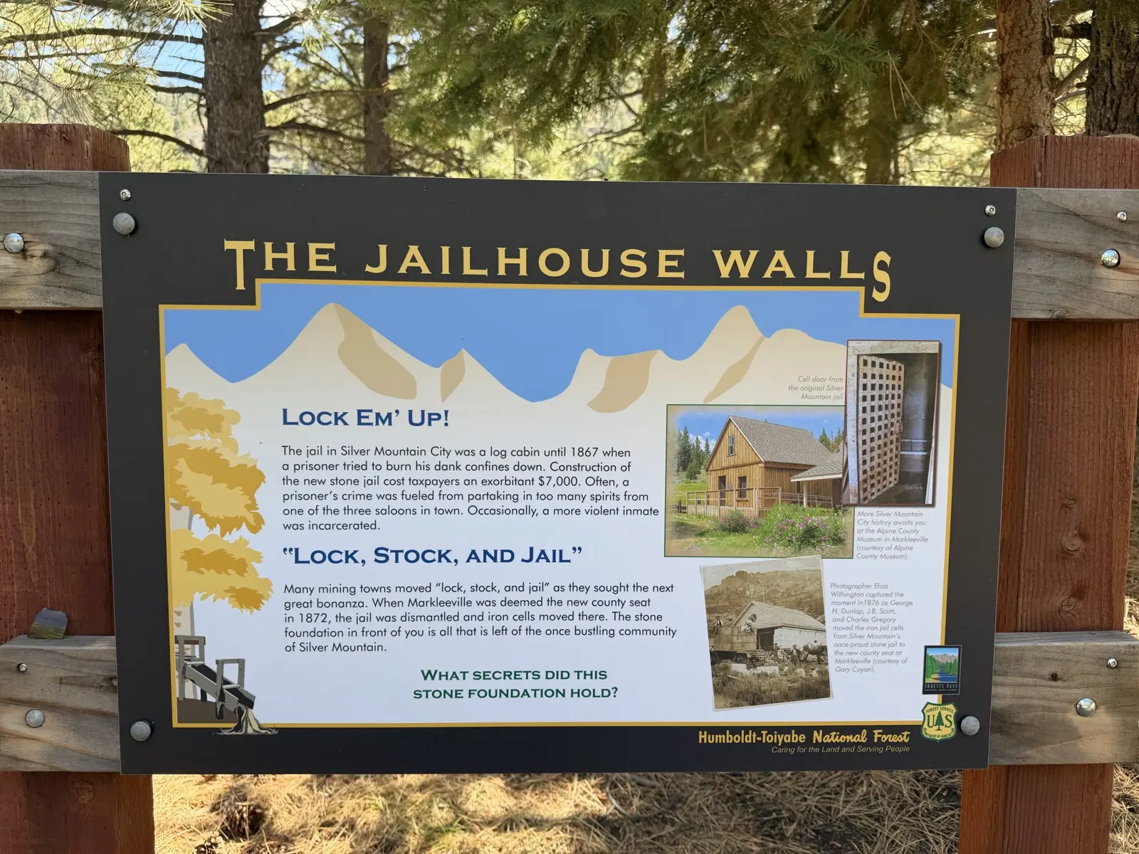 The Jailhouse Walls sign — the stone jail whose iron cells moved to Markleeville in 1872 —.