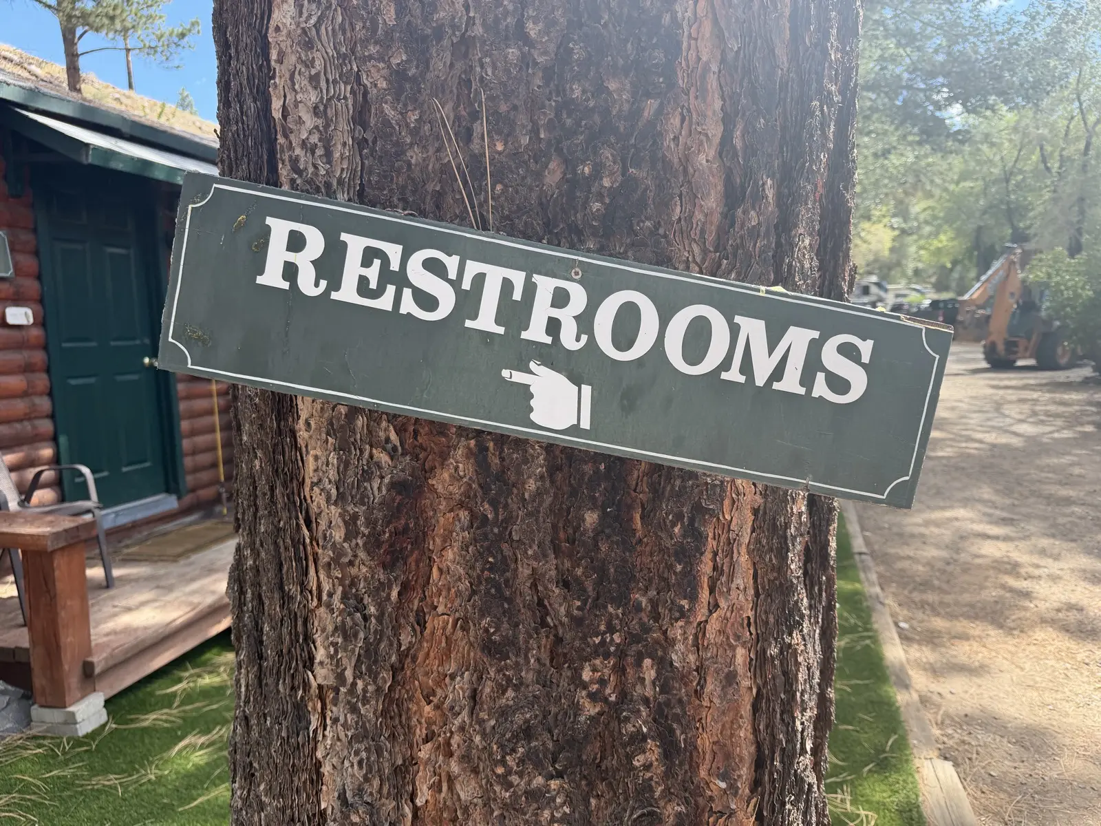 The restrooms sign on the big pine —.