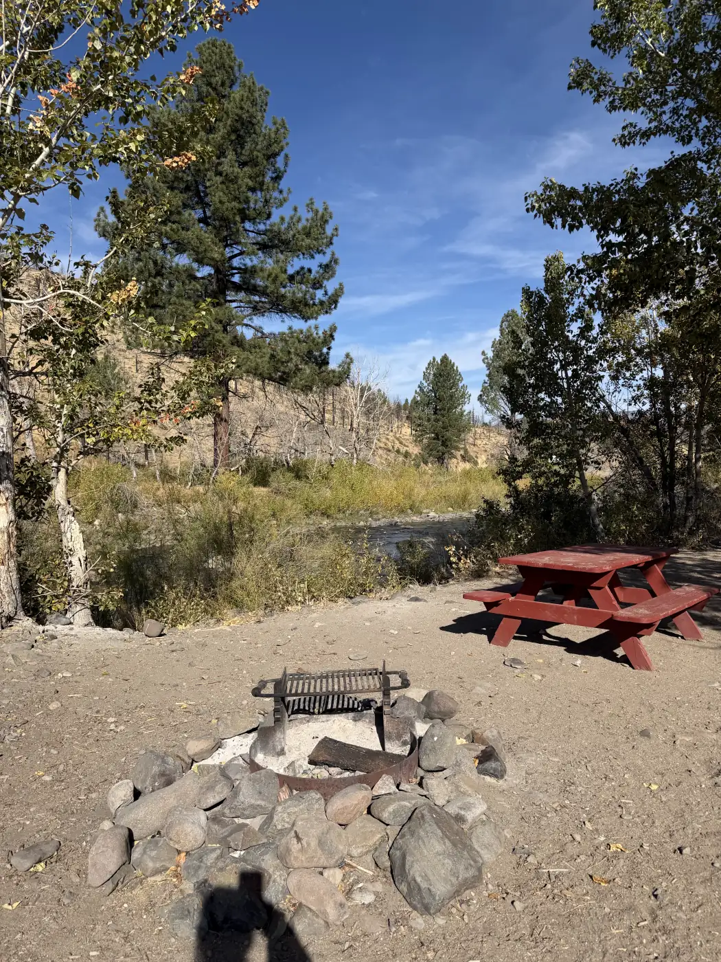 Riverside site 7 — the red picnic table and the fire ring, the East Fork right there — the owner's photograph, September 2026.